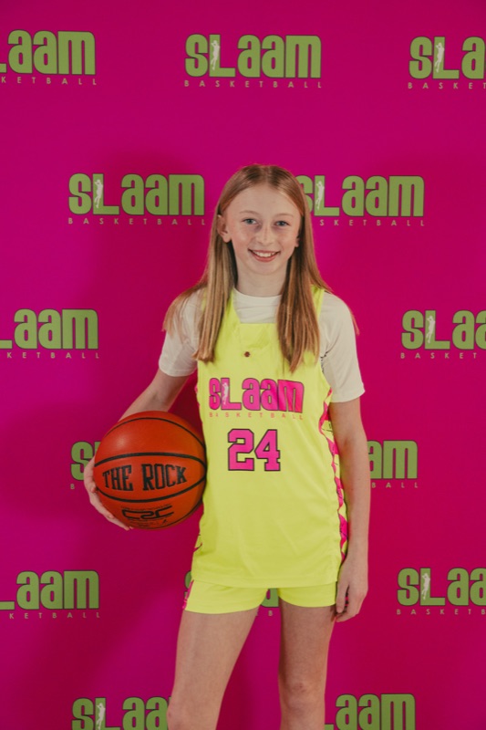 A SLAAM player in jersey holding a basketball.