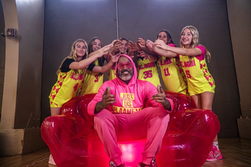 A SLAAM coach with players doing the SLAAM hand sign.