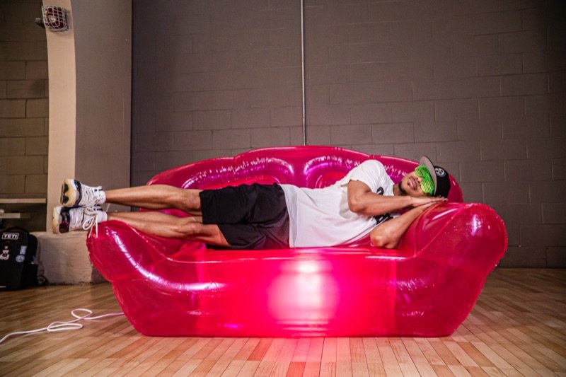 A SLAAM player on the program pink couch.